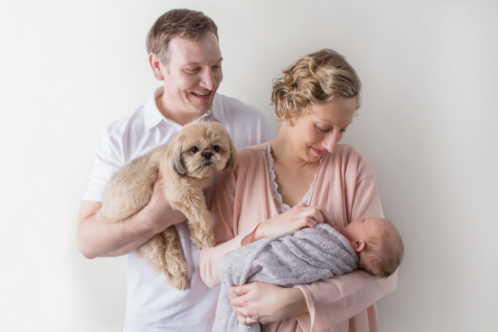 Dad holding dog and baby